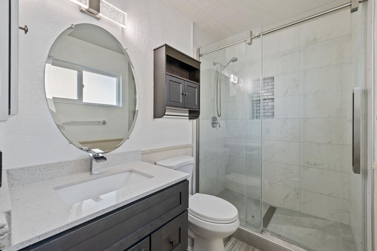 22 Sharon Drive Bay Point, CA 94565 - Photo 27 of 33 a bathroom with a sink a toilet a mirror and shower