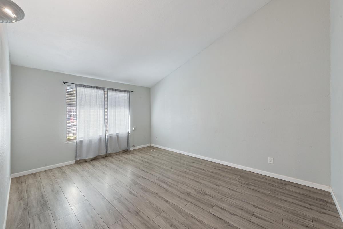22 Sharon Drive Bay Point, CA 94565 - Photo 4 of 33 an empty room with wooden floor and windows