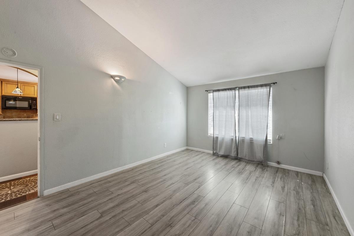 22 Sharon Drive Bay Point, CA 94565 - Photo 6 of 33 an empty room with wooden floor and windows