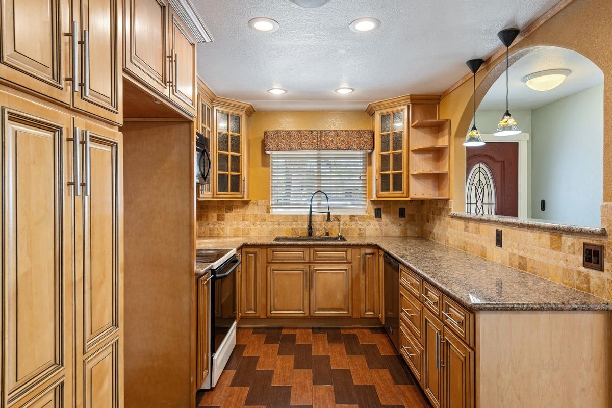 22 Sharon Drive Bay Point, CA 94565 - Photo 9 of 33 a kitchen with granite countertop sink stainless steel appliances a window and a sink