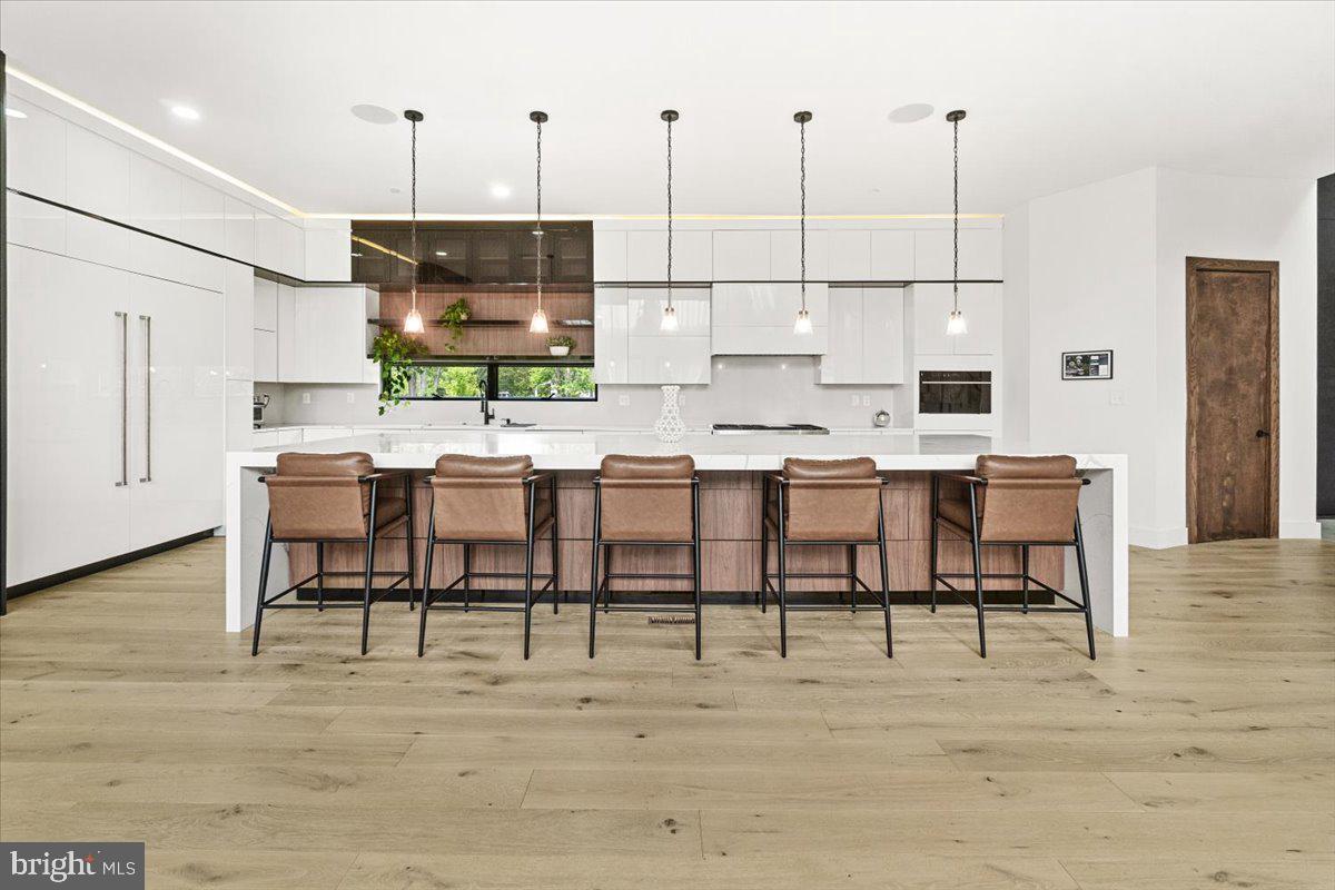 15807 Thompson Road Silver Spring, MD 20905 - Photo 18 of 82 a dining room with furniture a rug a chandelier and wooden floor