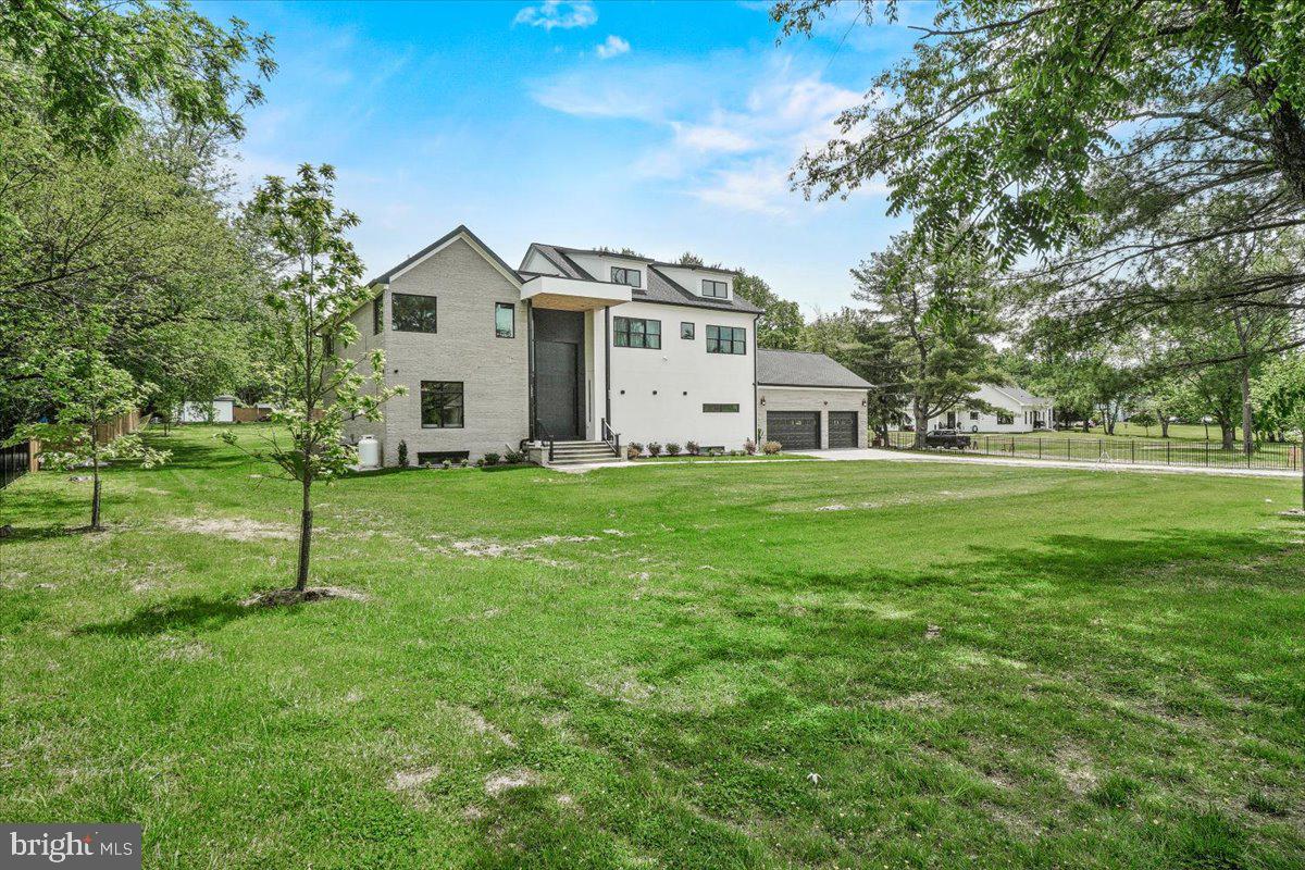 15807 Thompson Road Silver Spring, MD 20905 - Photo 2 of 82 a white house with a small yard and big trees with wooden fence