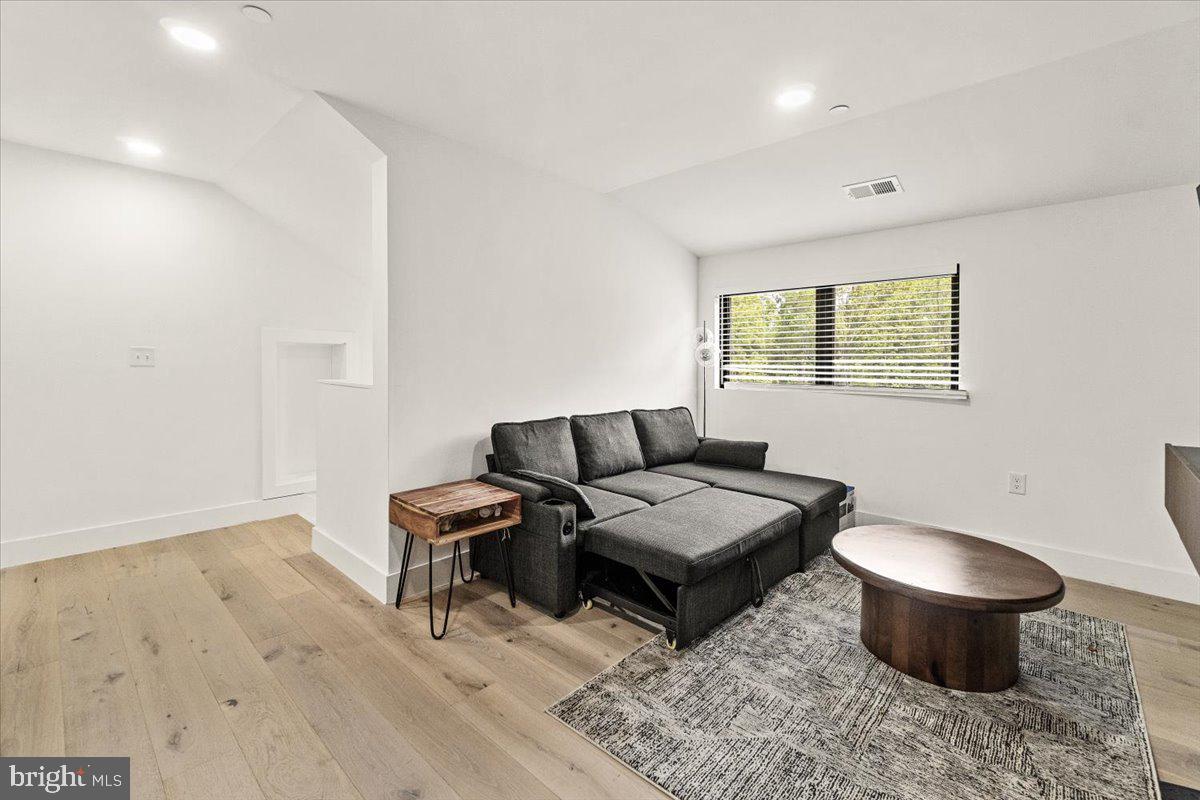 15807 Thompson Road Silver Spring, MD 20905 - Photo 47 of 82 a living room with furniture a rug and a window