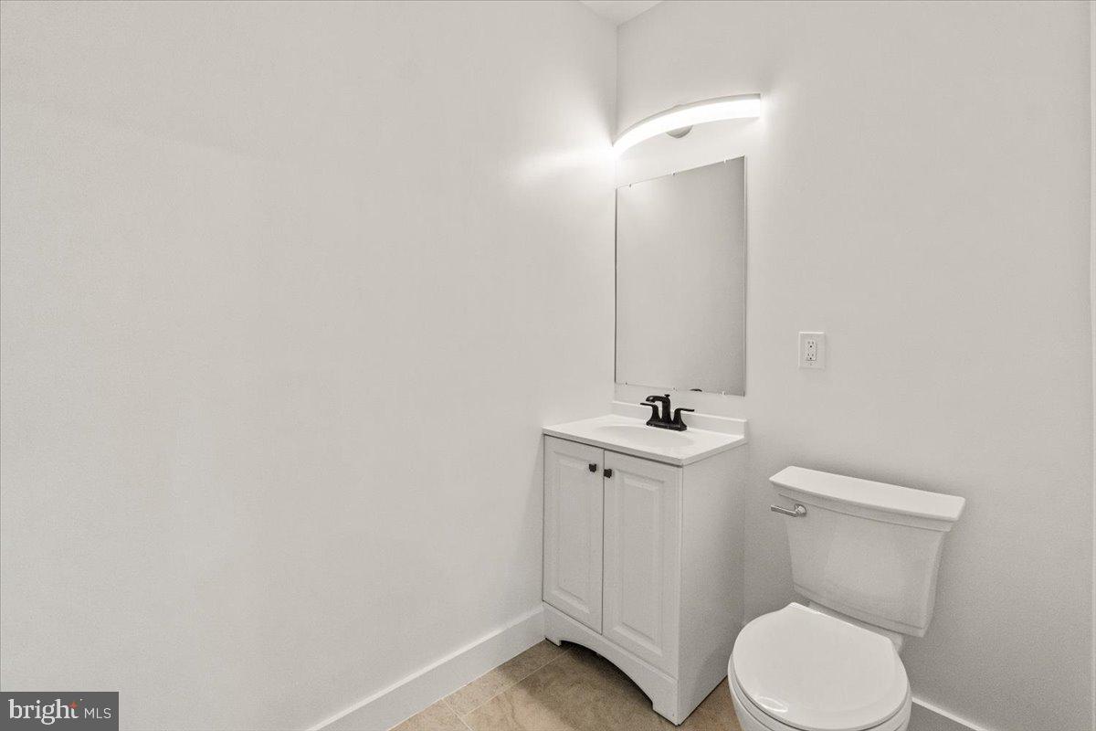 15807 Thompson Road Silver Spring, MD 20905 - Photo 54 of 82 a bathroom with a toilet a sink and mirror