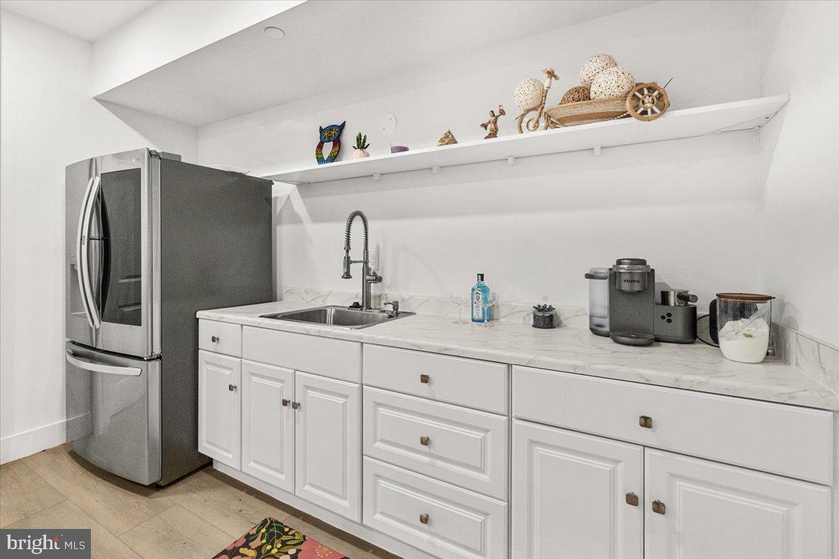 15807 Thompson Road Silver Spring, MD 20905 - Photo 61 of 82 a kitchen with cabinets stainless steel appliances and a sink