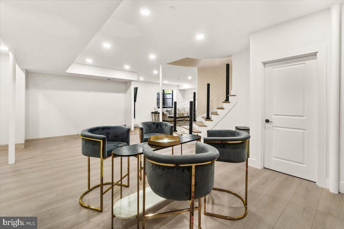 15807 Thompson Road Silver Spring, MD 20905 - Photo 62 of 82 a kitchen with stainless steel appliances kitchen island a table and chairs in it