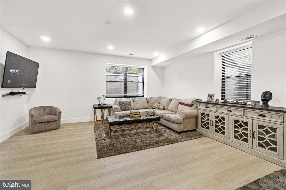15807 Thompson Road Silver Spring, MD 20905 - Photo 63 of 82 a living room with furniture a flat screen tv and a couch