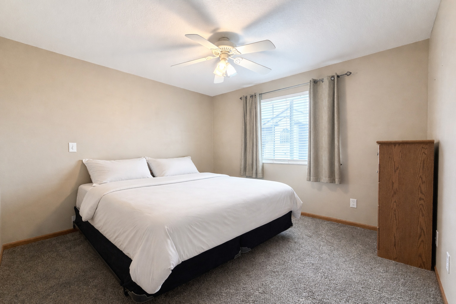 213 East Price Street, Unit 202 Eldridge, IA 52748 - Photo 16 of 20 a large bed sitting in a bedroom next to a window and a chandelier