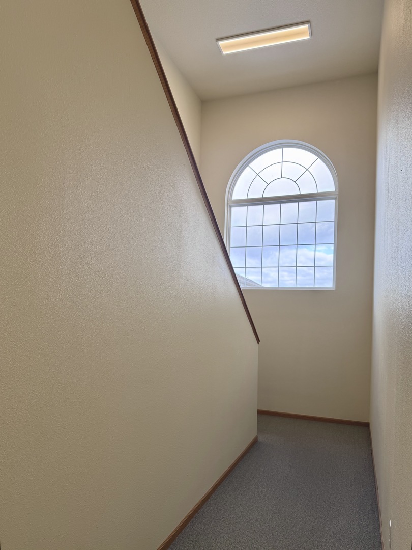 213 East Price Street, Unit 202 Eldridge, IA 52748 - Photo 3 of 20 an empty room with windows