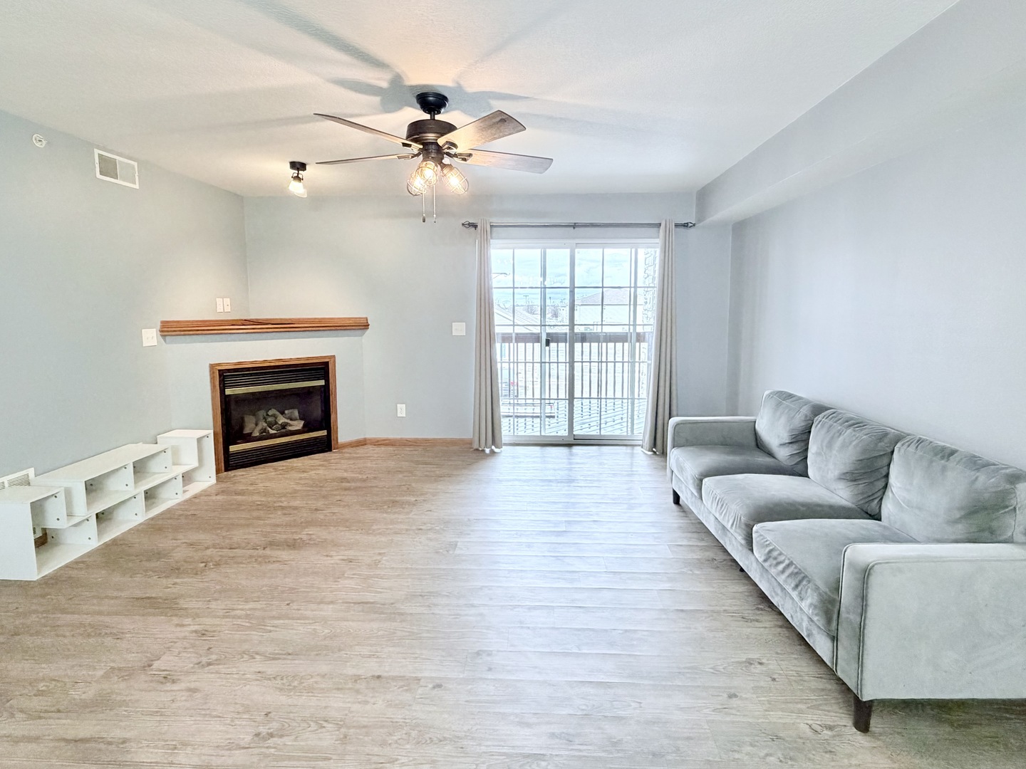 213 East Price Street, Unit 202 Eldridge, IA 52748 - Photo 6 of 20 a living room with furniture and a fireplace
