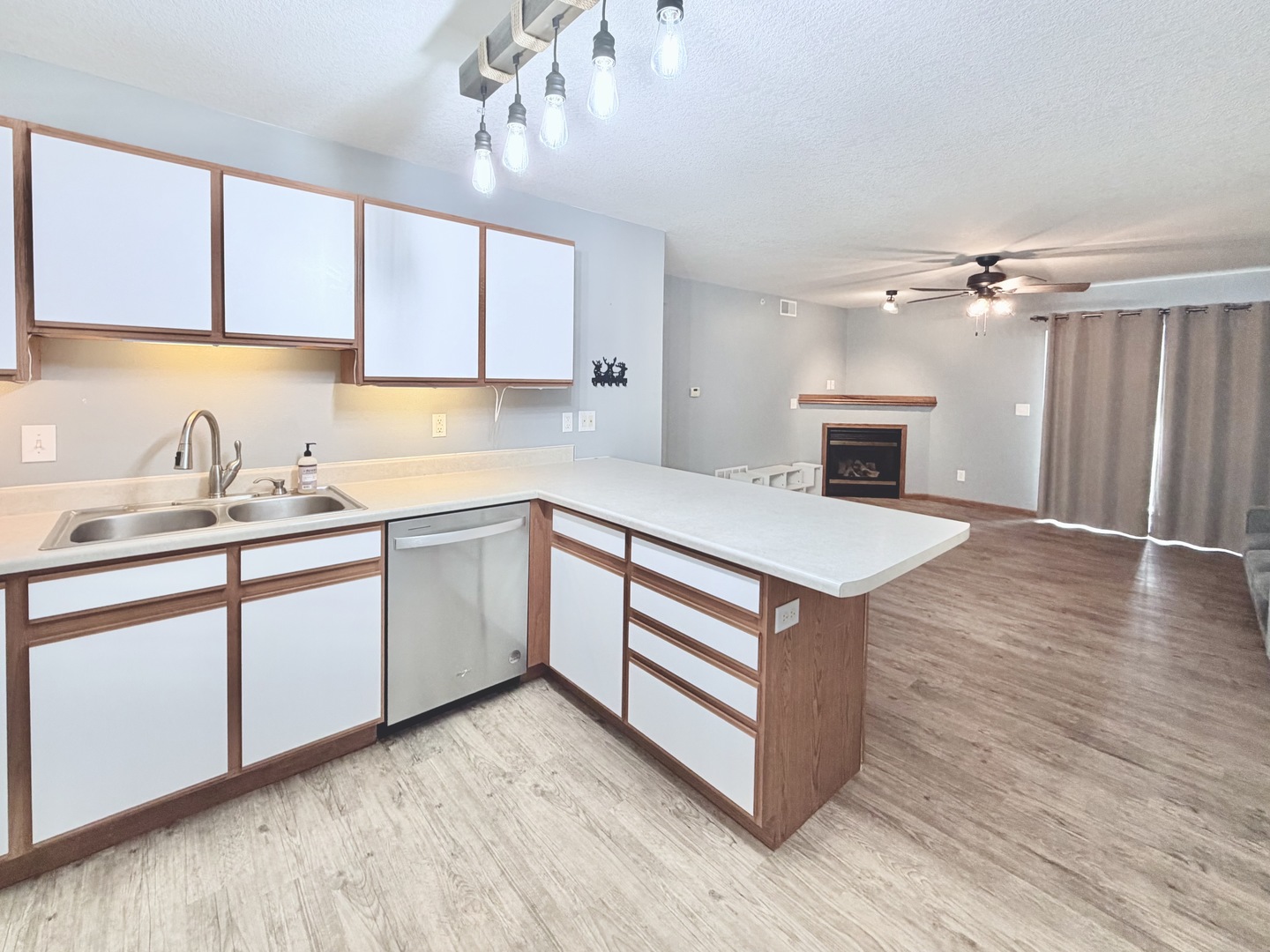 213 East Price Street, Unit 202 Eldridge, IA 52748 - Photo 9 of 20 a kitchen with stainless steel appliances granite countertop a white cabinets a sink and dishwasher