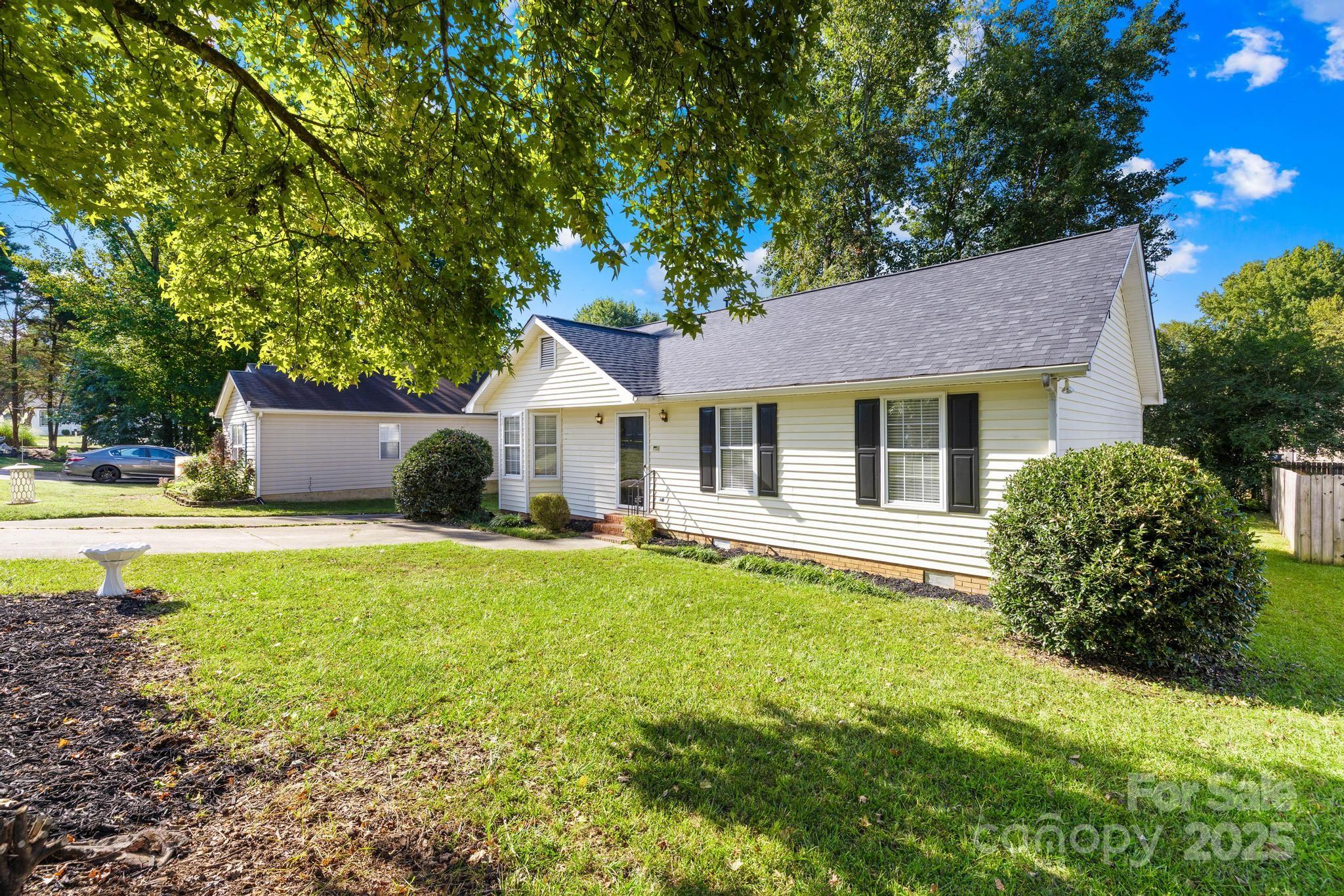 4805 Shea Court Monroe, NC 28110 - Photo 27 of 35 a front view of a house with a garden and porch