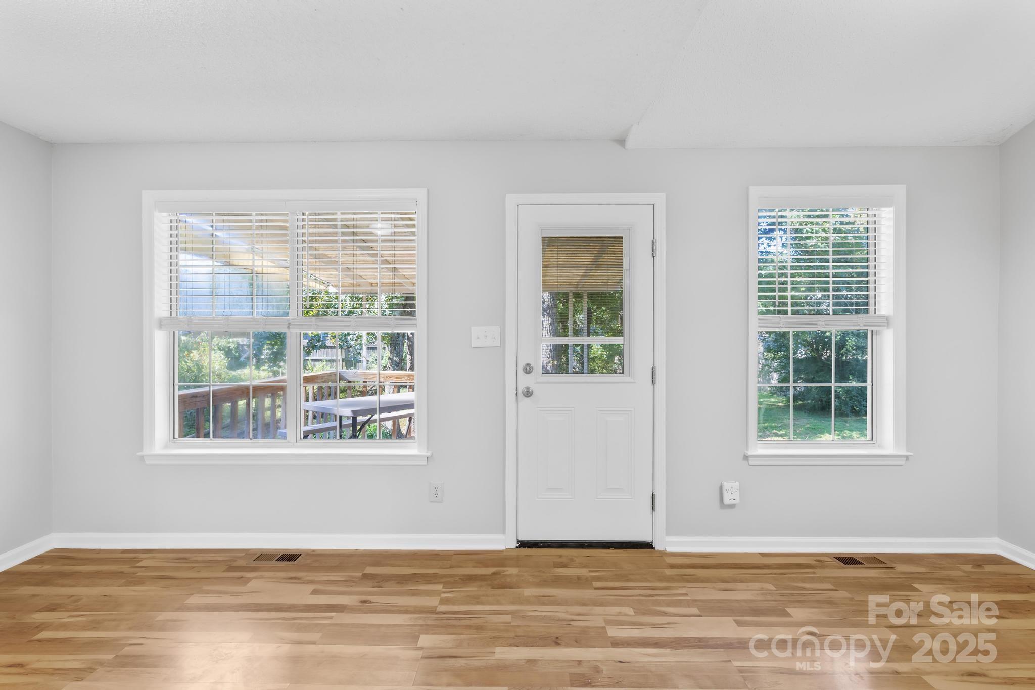 4805 Shea Court Monroe, NC 28110 - Photo 4 of 35 an empty room with wooden floor and windows