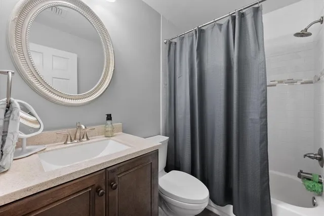 a bathroom with a sink a mirror a toilet and a mirror