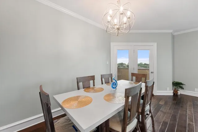 a view of a dining room with furniture wooden floor and chandelier