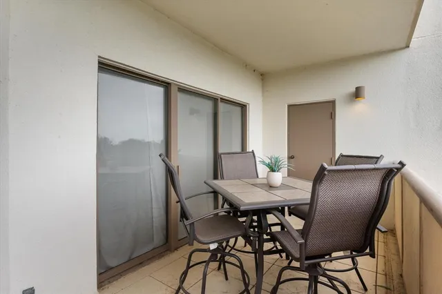 a view of a dining room with furniture and a mirror