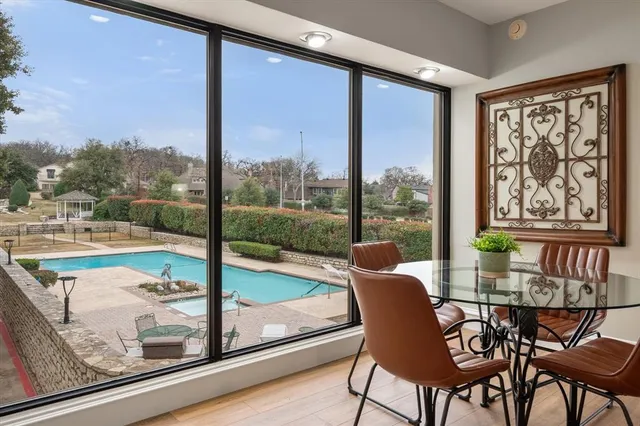 a view of a dining room with furniture wooden floor and a floor to ceiling window
