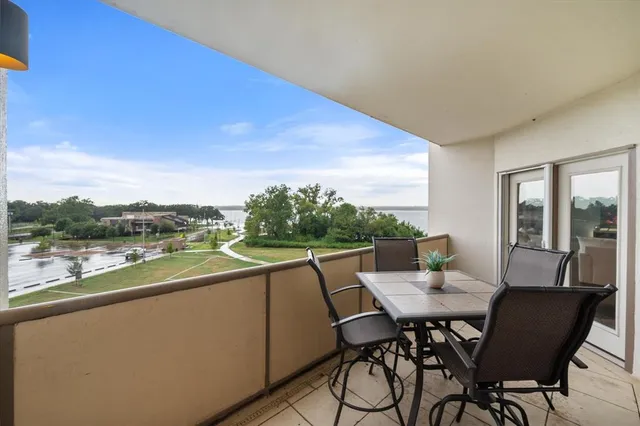a view of a balcony dining table and chairs