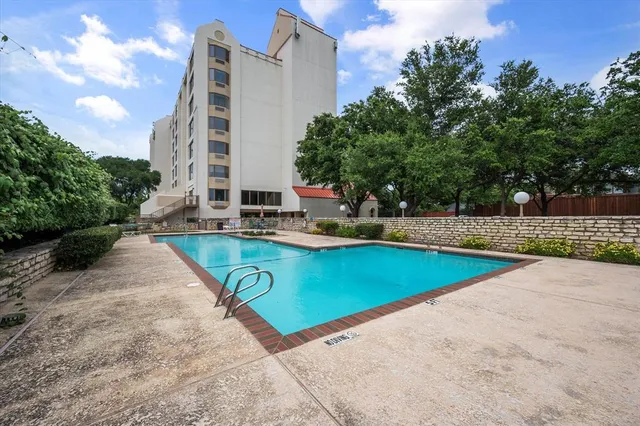a view of a swimming pool with an outdoor seating