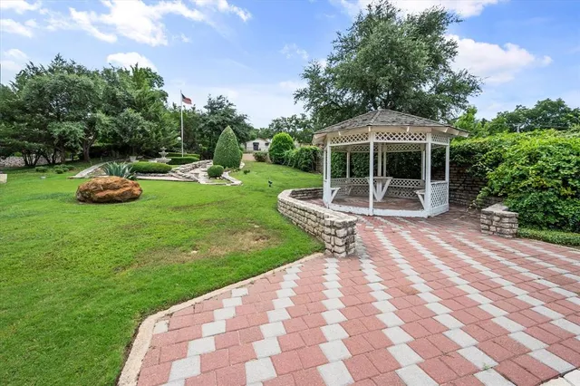a view of a backyard with a garden and entertaining space