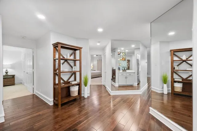 a view of a living room and kitchen with hardwood floor