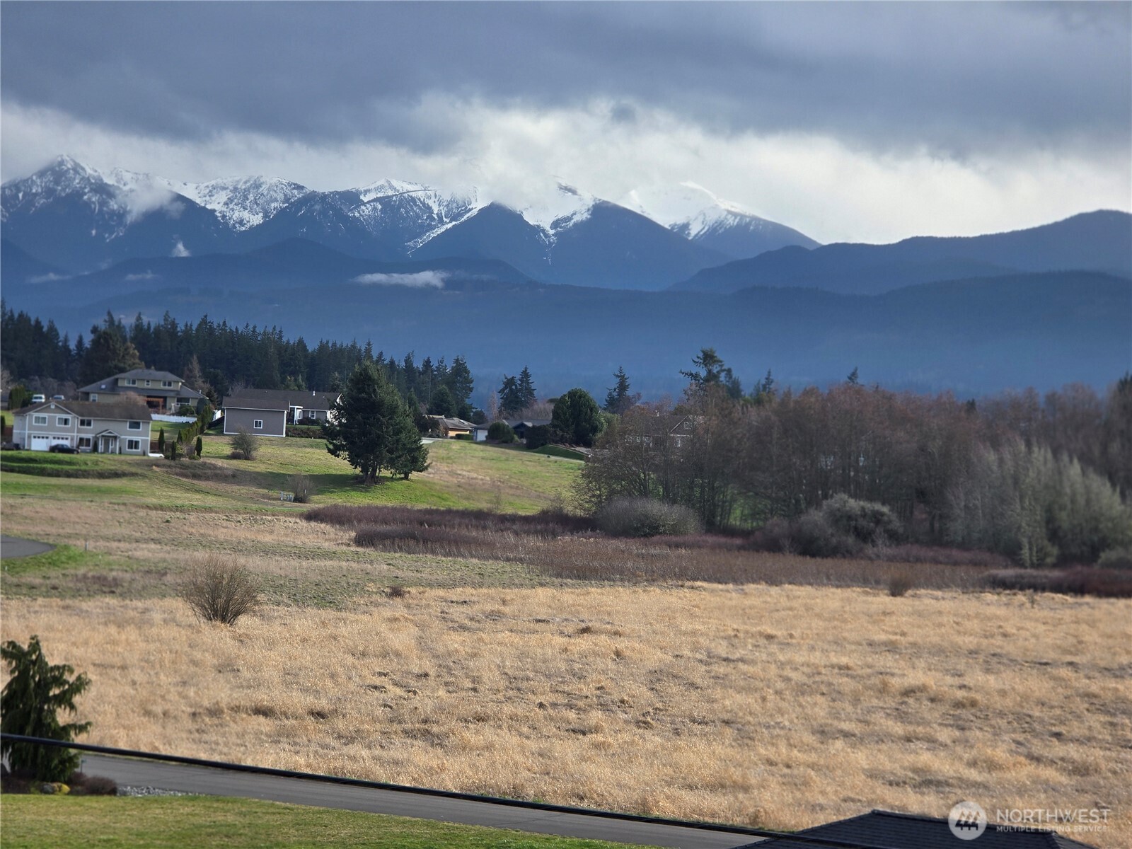 104 Green Valley Lane Sequim, WA 98382 - Photo 11 of 12 a view of a town with mountains in the background