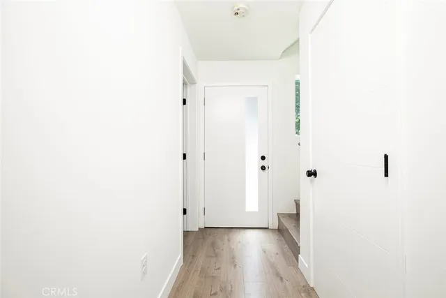 a view of a hallway with wooden floor