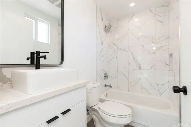 a bathroom with a sink a toilet and a bathtub