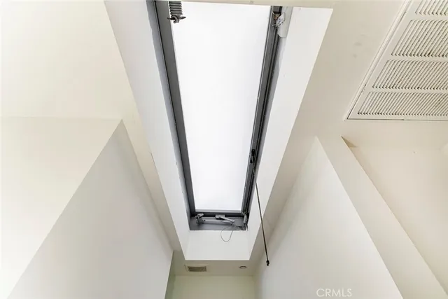 a view of a house with a wooden fence