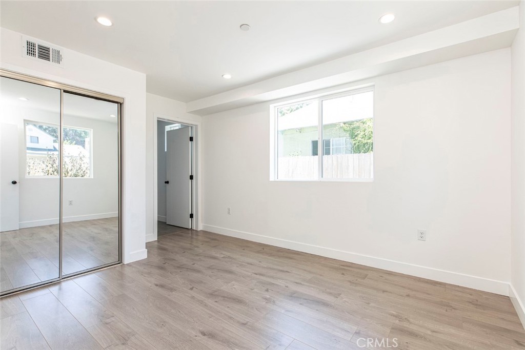 1843 West 20th Street Los Angeles, CA 90007 - Photo 5 of 38 an empty room with wooden floor and a window
