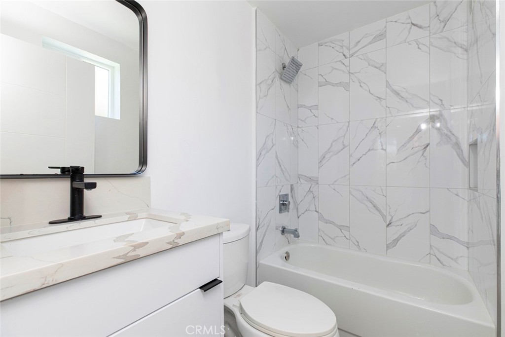 1843 West 20th Street Los Angeles, CA 90007 - Photo 8 of 38 a bathroom with a granite countertop bathtub sink vanity mirror and toilet