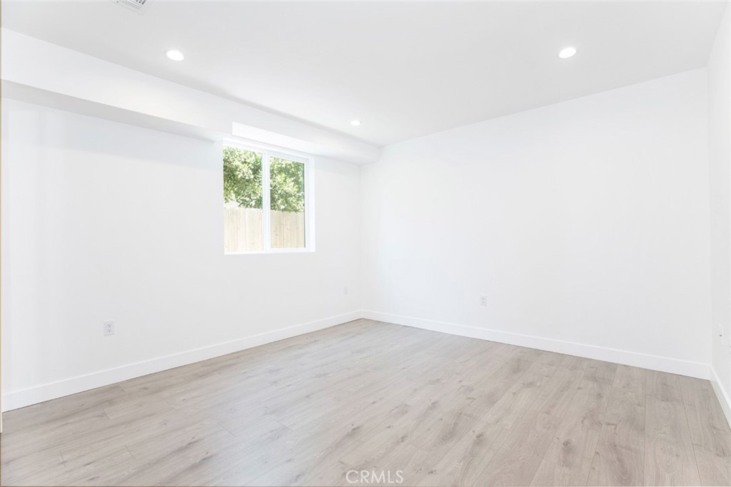 1843 West 20th Street Los Angeles, CA 90007 - Photo 9 of 38 an empty room with wooden floor and windows
