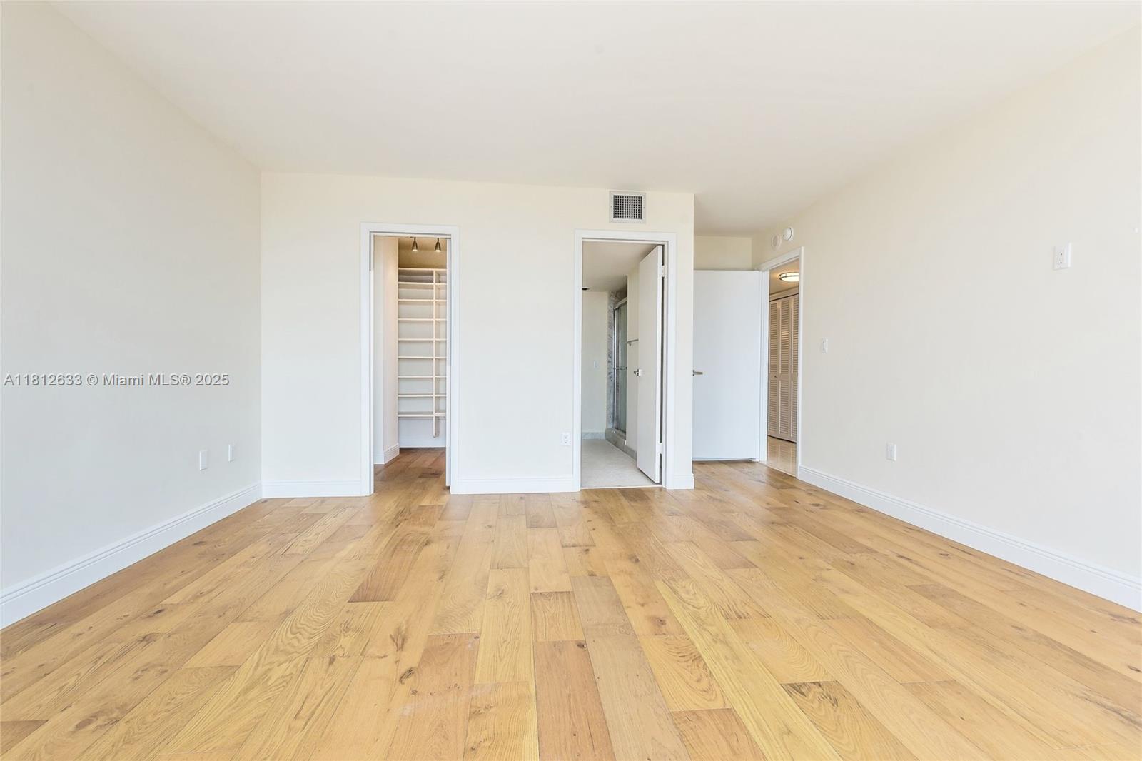 881 Ocean Drive, Unit 22A Key Biscayne, FL 33149 - Photo 12 of 26 a view of an empty room with wooden floor