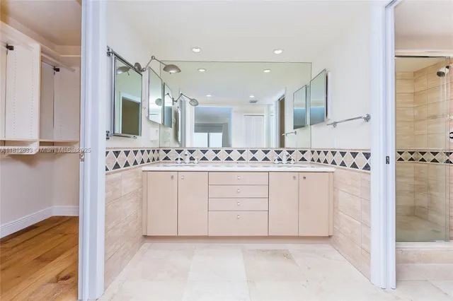 a bathroom with a sink a mirror and a shower