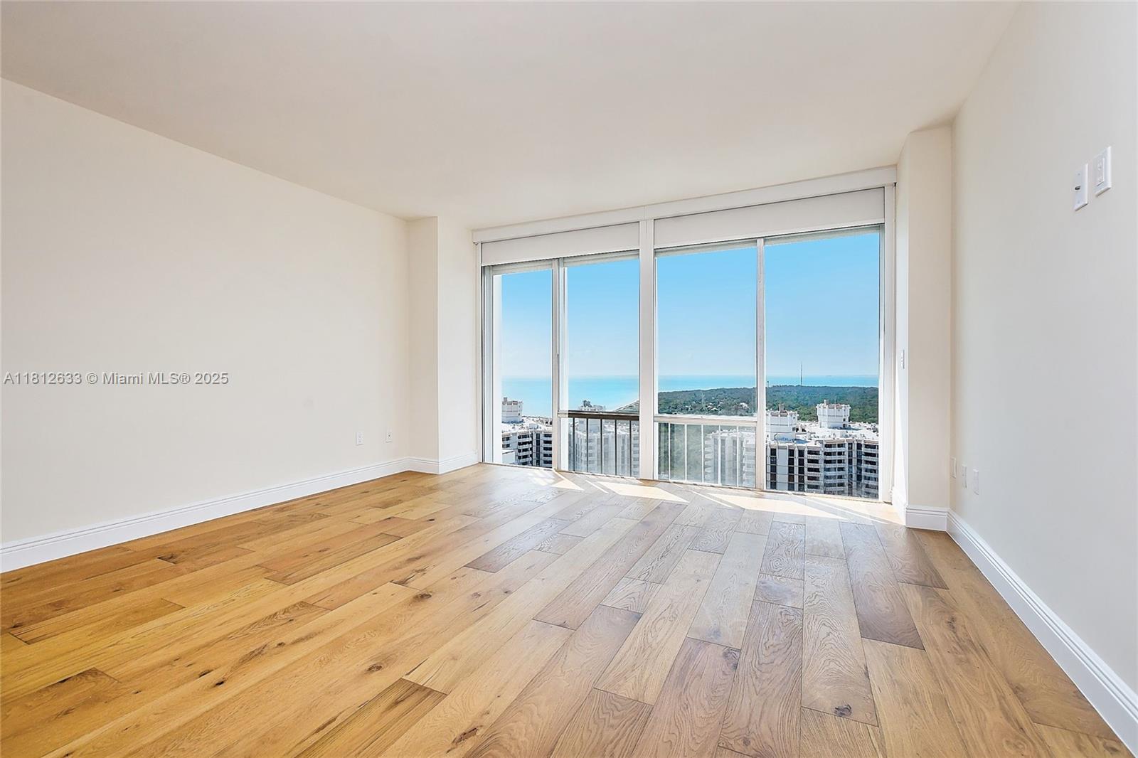 881 Ocean Drive, Unit 22A Key Biscayne, FL 33149 - Photo 15 of 26 a view of big room with wooden floor and balcony