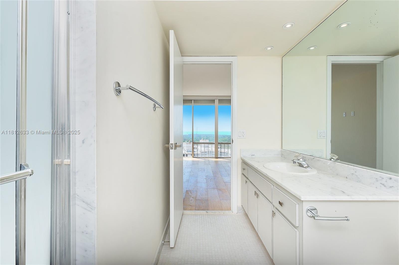 881 Ocean Drive, Unit 22A Key Biscayne, FL 33149 - Photo 18 of 26 a bathroom with a sink and a mirror