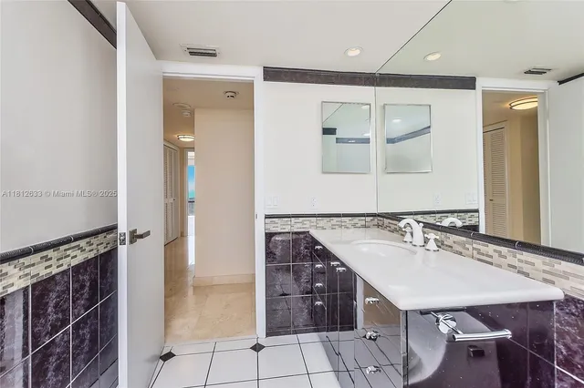 a bathroom with a sink a vanity and a mirror