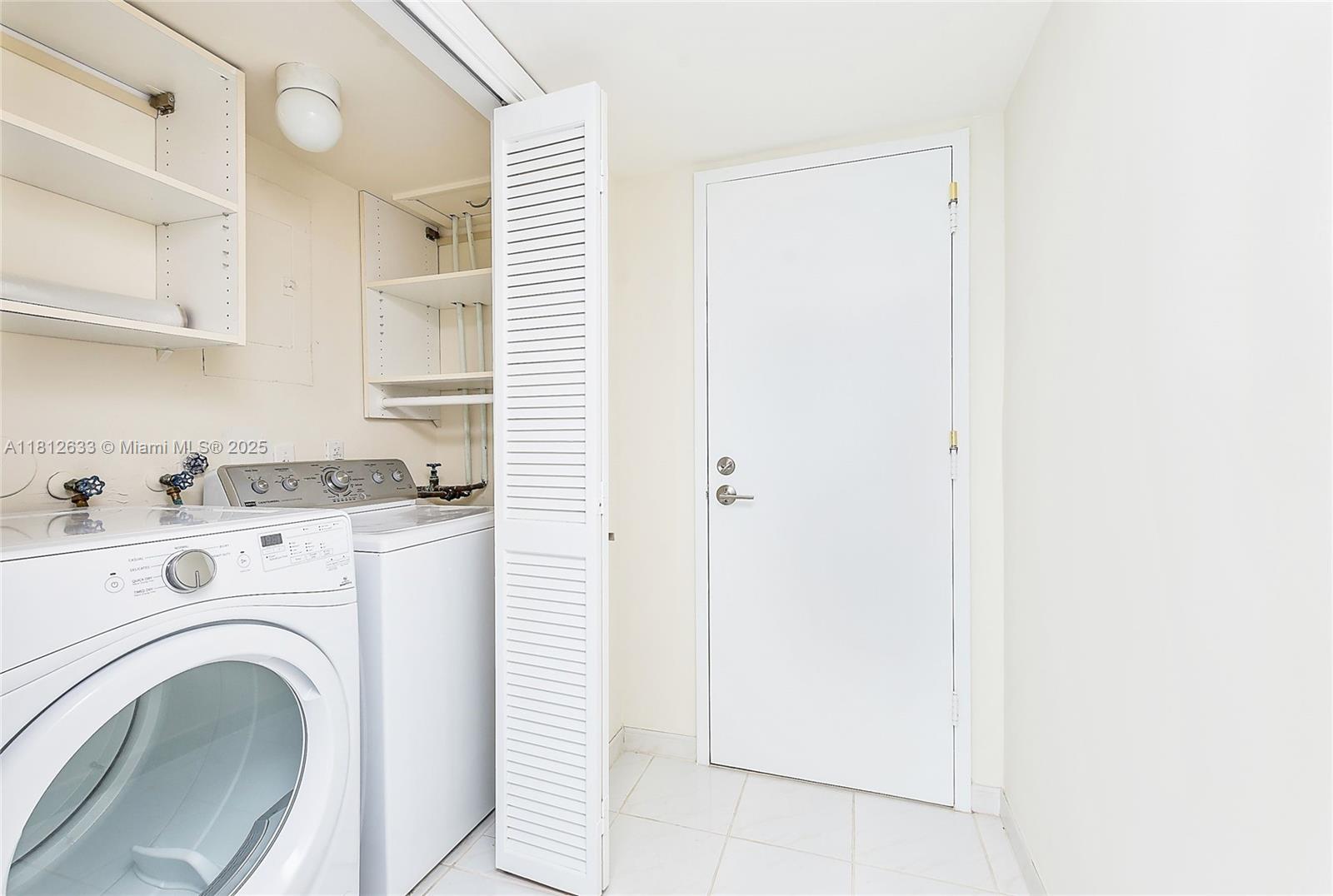 881 Ocean Drive, Unit 22A Key Biscayne, FL 33149 - Photo 8 of 26 a view of washer and dryer in a kitchen