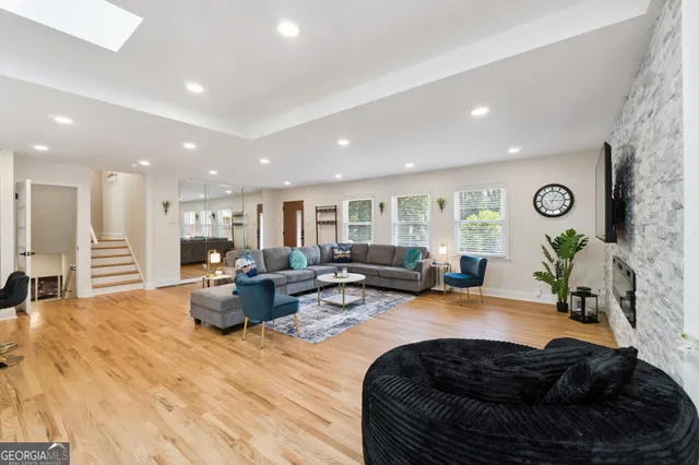 a living room with furniture and a wooden floor