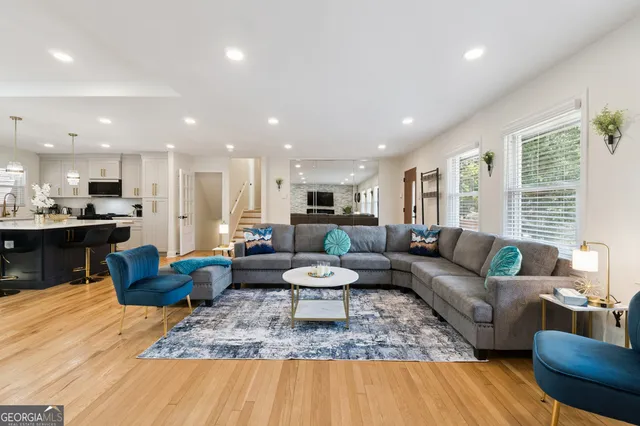 a living room with furniture and wooden floor