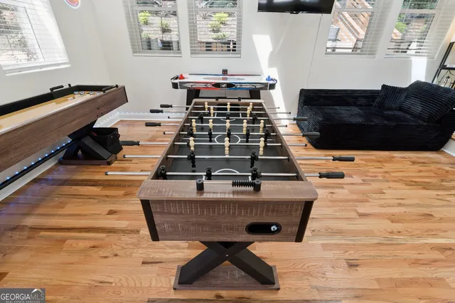 a bathroom with a granite countertop sink a large mirror a toilet and a mirror