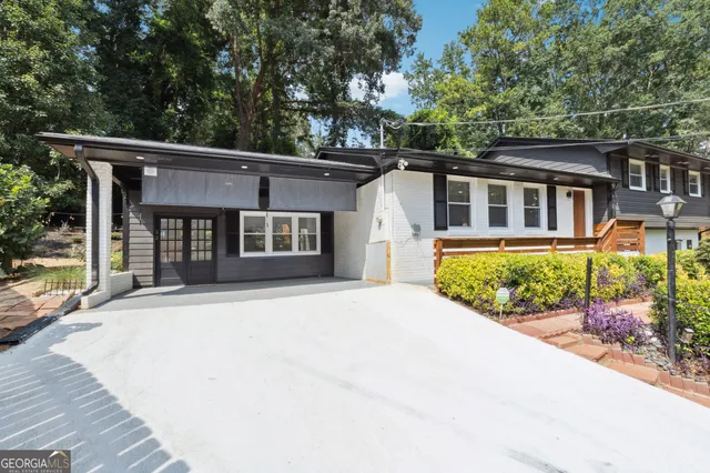 a living room with furniture a table and kitchen view