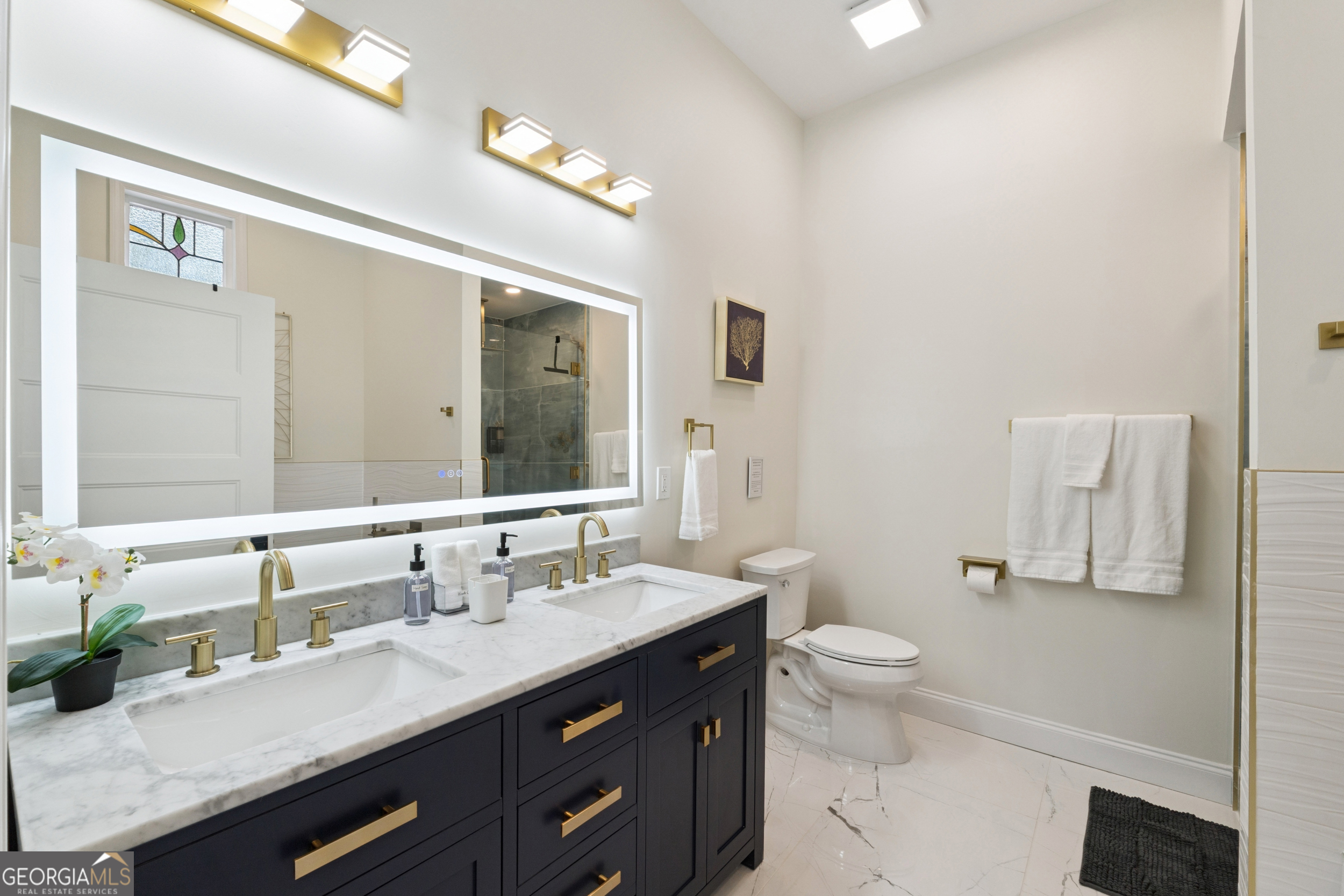 2139 Cedarbrook Court Southeast Atlanta, GA 30316 - Photo 35 of 69 a bathroom with a granite countertop sink a large mirror a toilet and a mirror