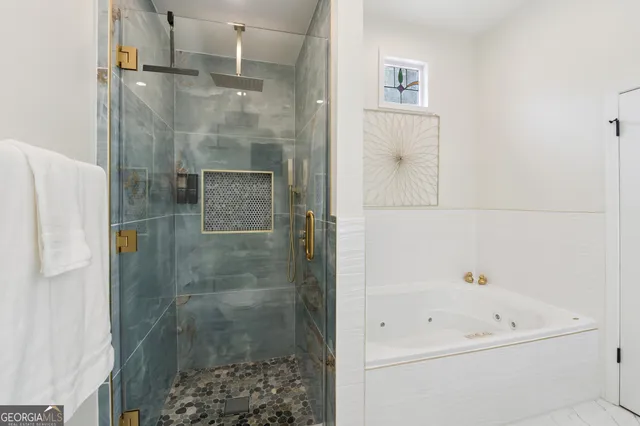 a living room with furniture a flat screen tv and kitchen area