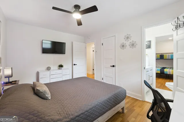 a bedroom with a bed and a flat screen tv