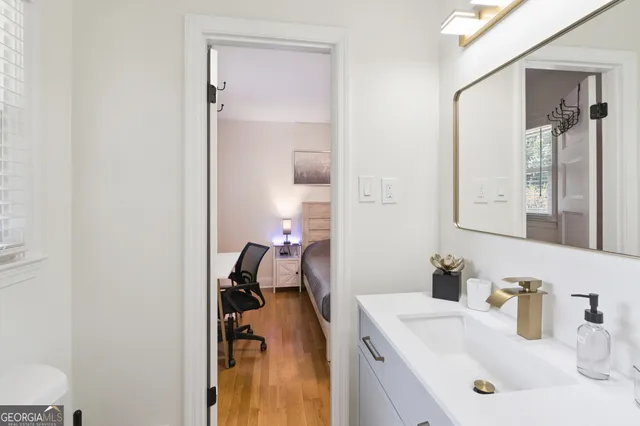 a bathroom with a sink a toilet and a mirror