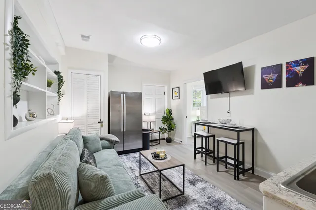 a view of a patio with table and chairs potted plants with wooden floor