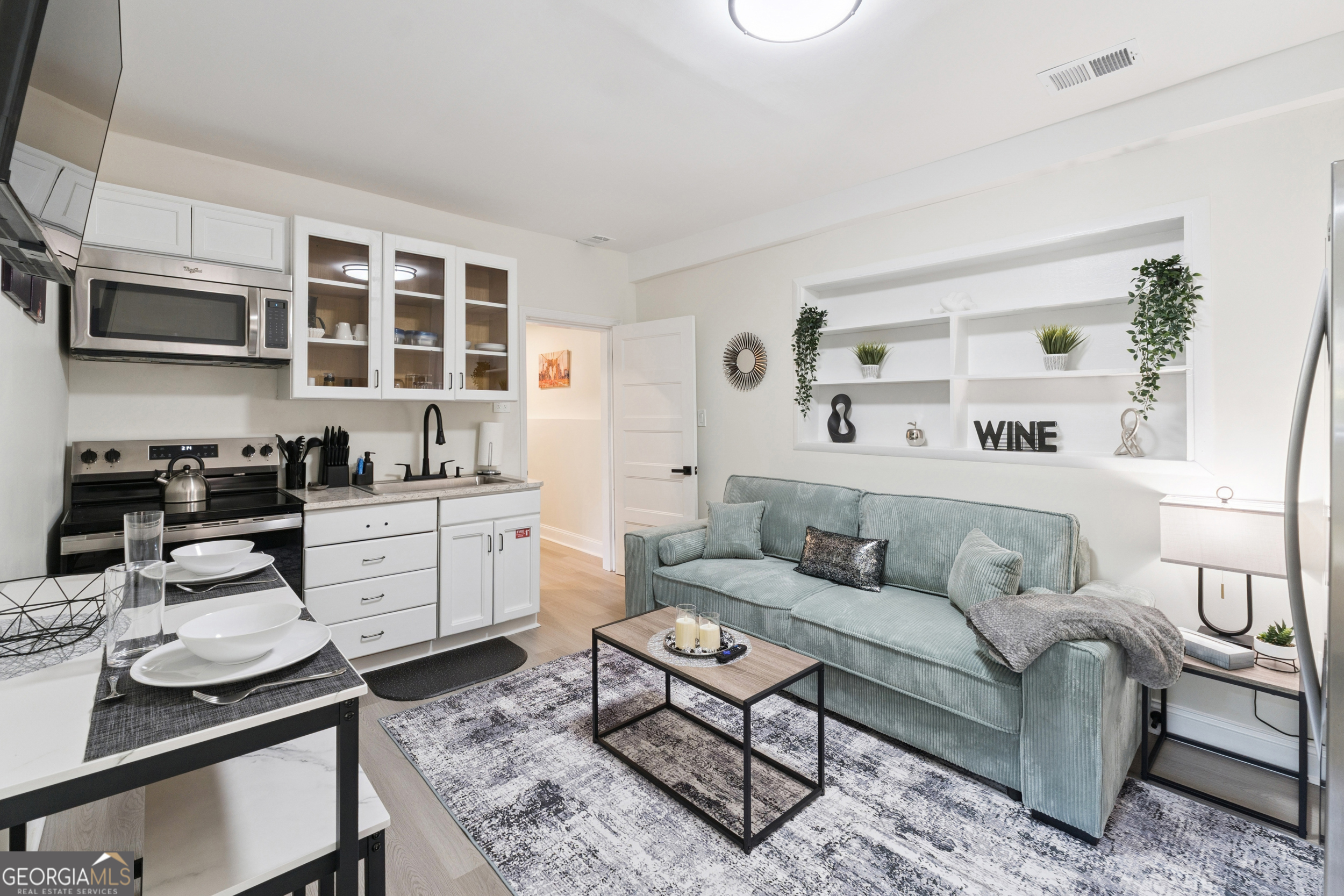 2139 Cedarbrook Court Southeast Atlanta, GA 30316 - Photo 52 of 69 a living room with furniture a flat screen tv and kitchen area