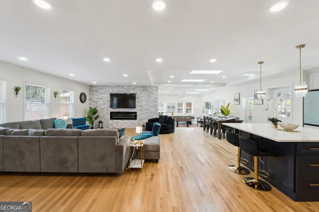 a living room with furniture wooden floor and a flat screen tv