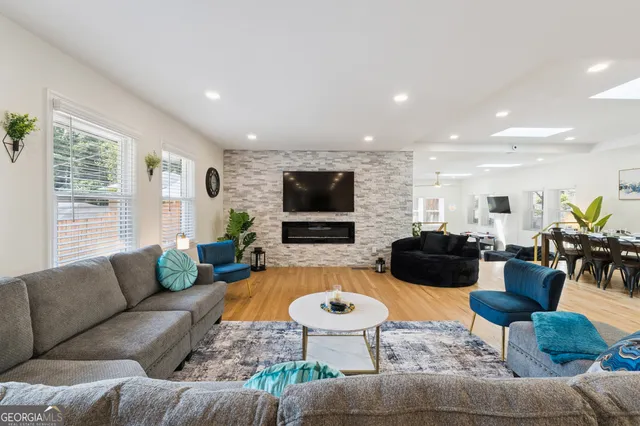 a living room with fireplace furniture and a flat screen tv
